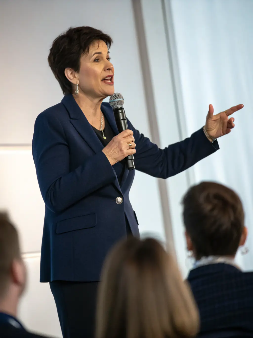 A visually appealing image of a keynote speaker presenting at a business conference, with a focus on capital investment and asset management.