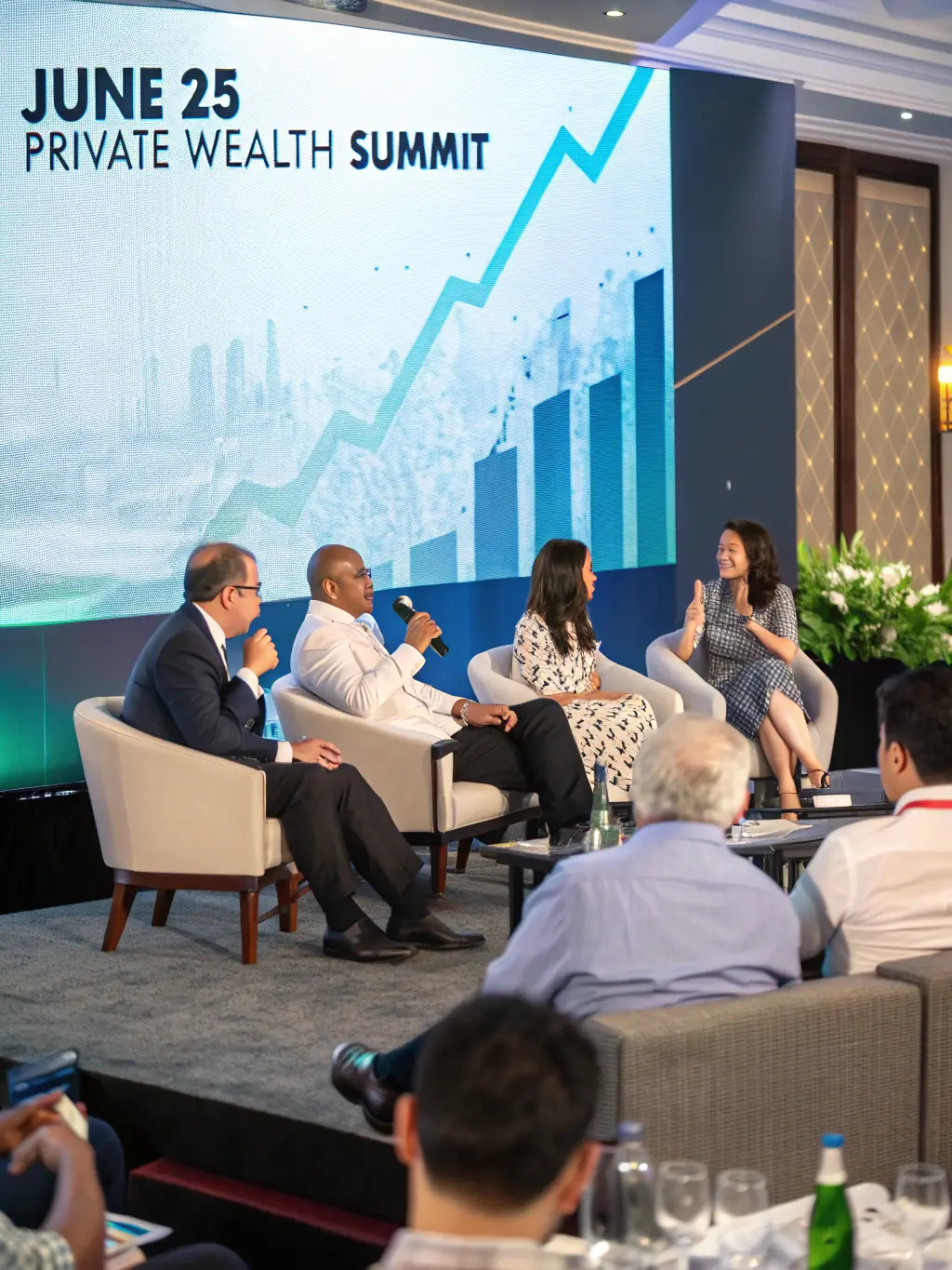 A photograph of a panel discussion at a business conference, featuring diverse speakers and an engaged audience, with a focus on investment strategies.